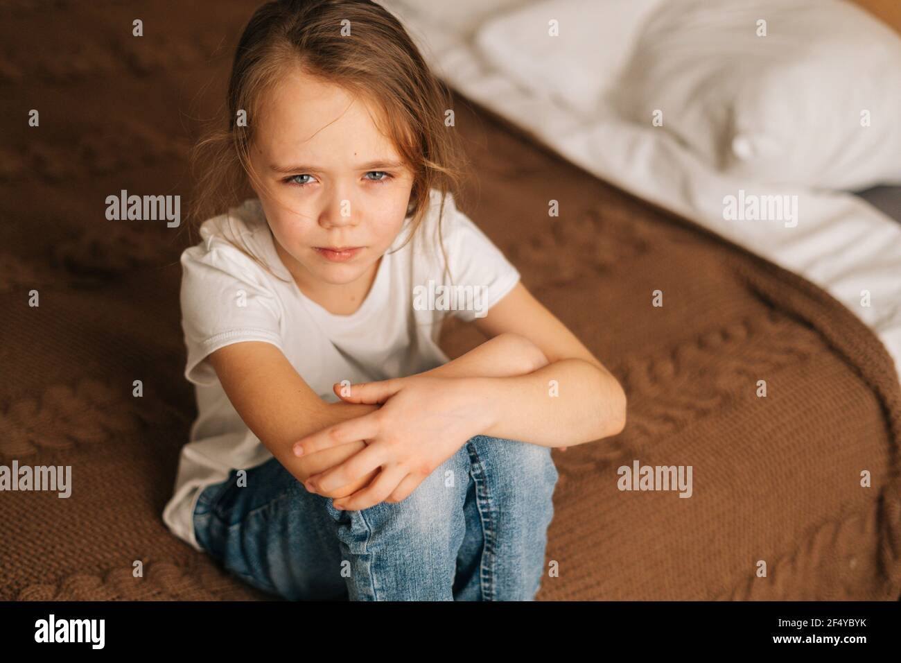 wet bed girl Top close-up view of distraught beautiful little girl with wet eyes from  tears sits on bed in bedroom and looking at camera Stock Photo - Alamy