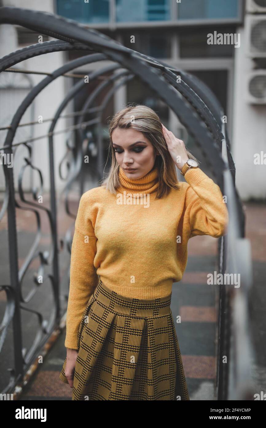 Woman in yellow sweater wearing hi-res stock photography and images - Alamy