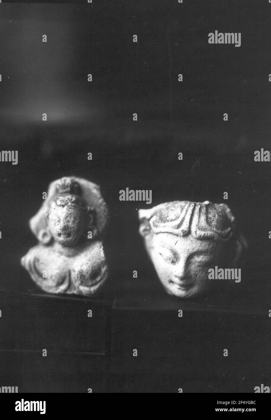 China. DandanOilik (?). Plaster stucco heads. Devi and Apsara (right