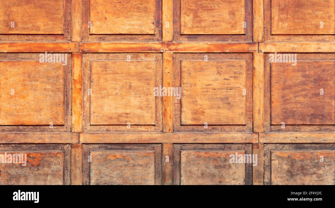 Wood door blank background texture. Brown color blocks with frame,  closed, aged, peeled artwork of secure surface. Wooden wall, floor, entrance. Wall Stock Photo