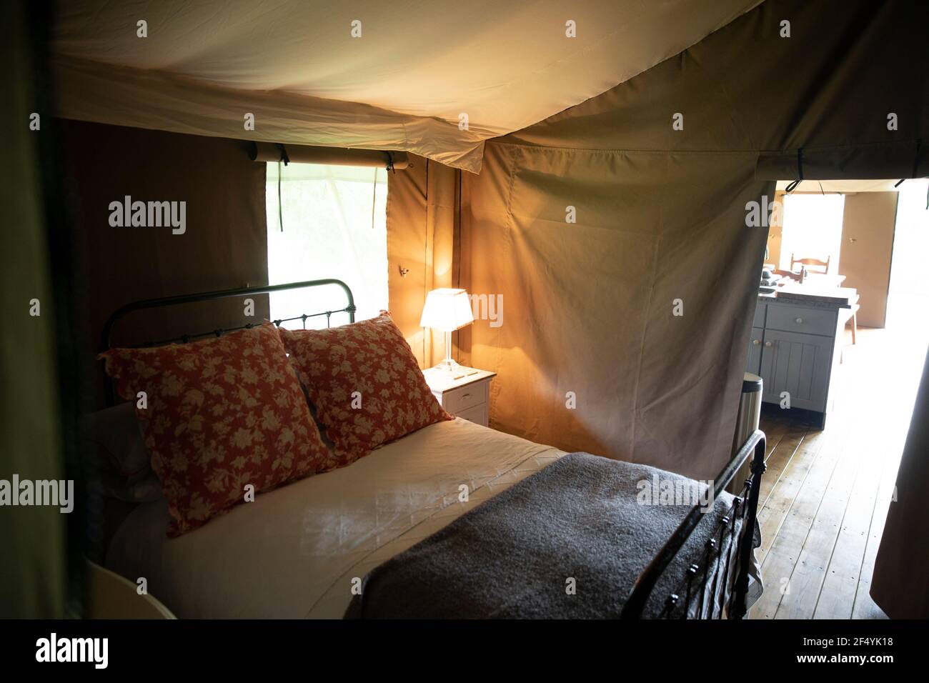 Bed and lamp in luxury camping yurt Stock Photo