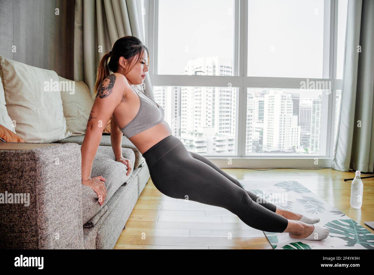 Young Asian healthy woman workout at home, exercise looking at videos, fit,  doing yoga, plank, abs, meditation. Bodyweight floor exercises. Healthy  Stock Photo - Alamy