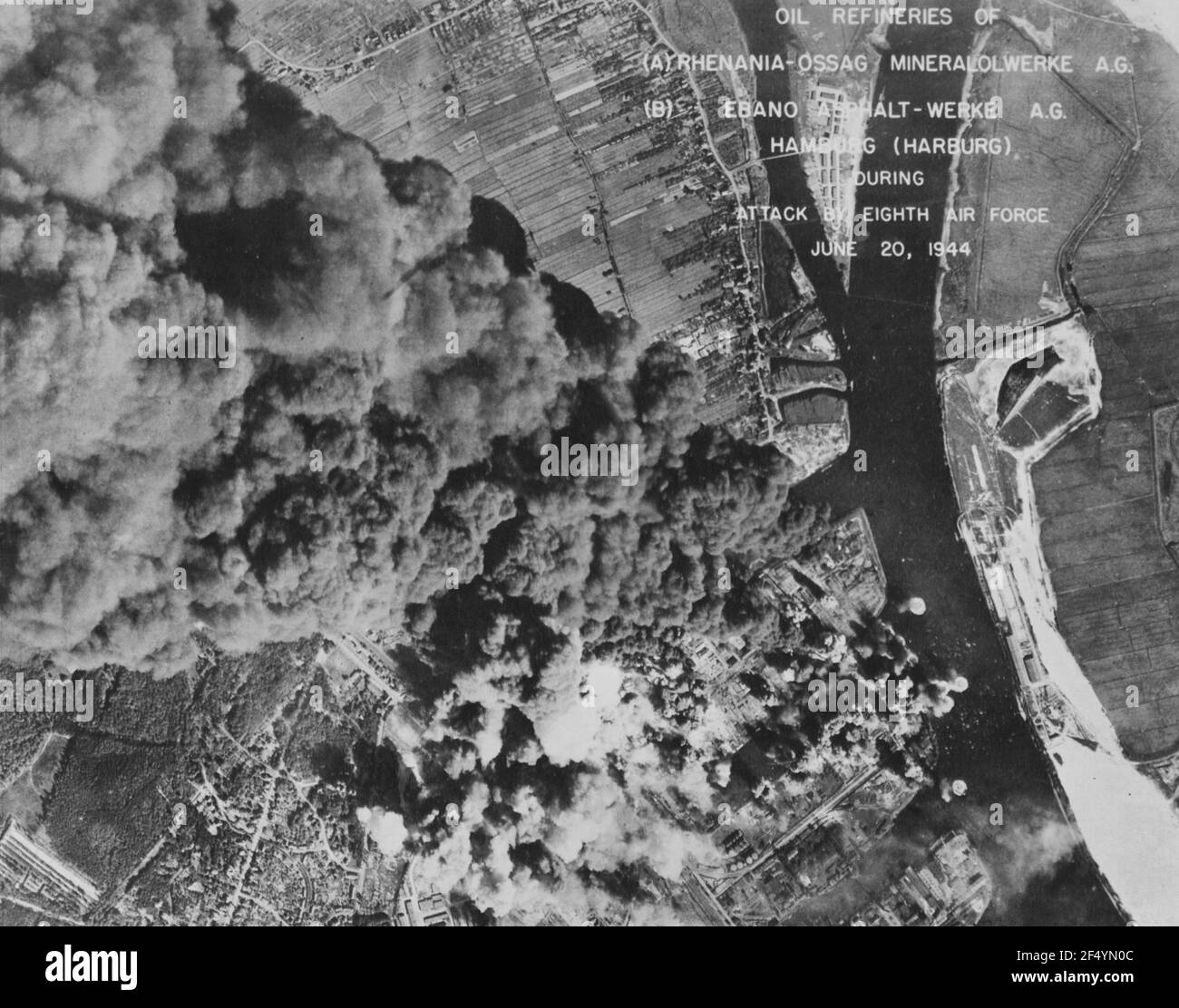 Oil refineries of (A) Rhenania-Ossag Mineralolwerke A.G. and (B) Ebano Asphalt-Werke A.G., Hamburg, Germany, during bombing by 8th Air Force 20 June 1944. 303nd Bomb Group Stock Photo