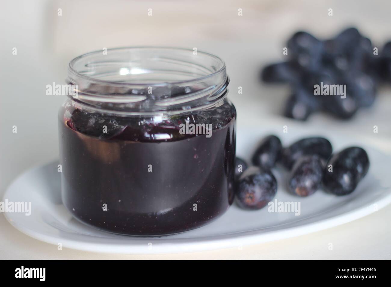 Home made Grape jam with three ingredients, seedless black grapes, sugar and lime juice. Shot on white background Stock Photo