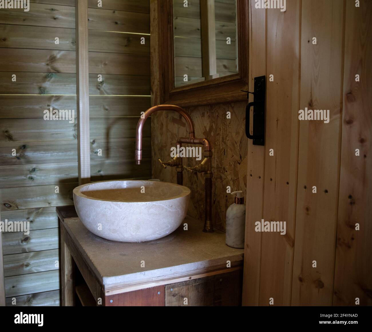 Bowl sink and copper faucet in cabin bathroom Stock Photo