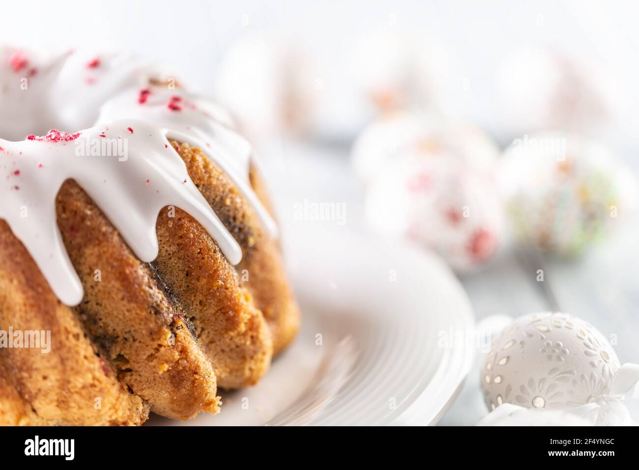 Festive easter marble cake with icing sugar with hand-decorated eggs. Stock Photo