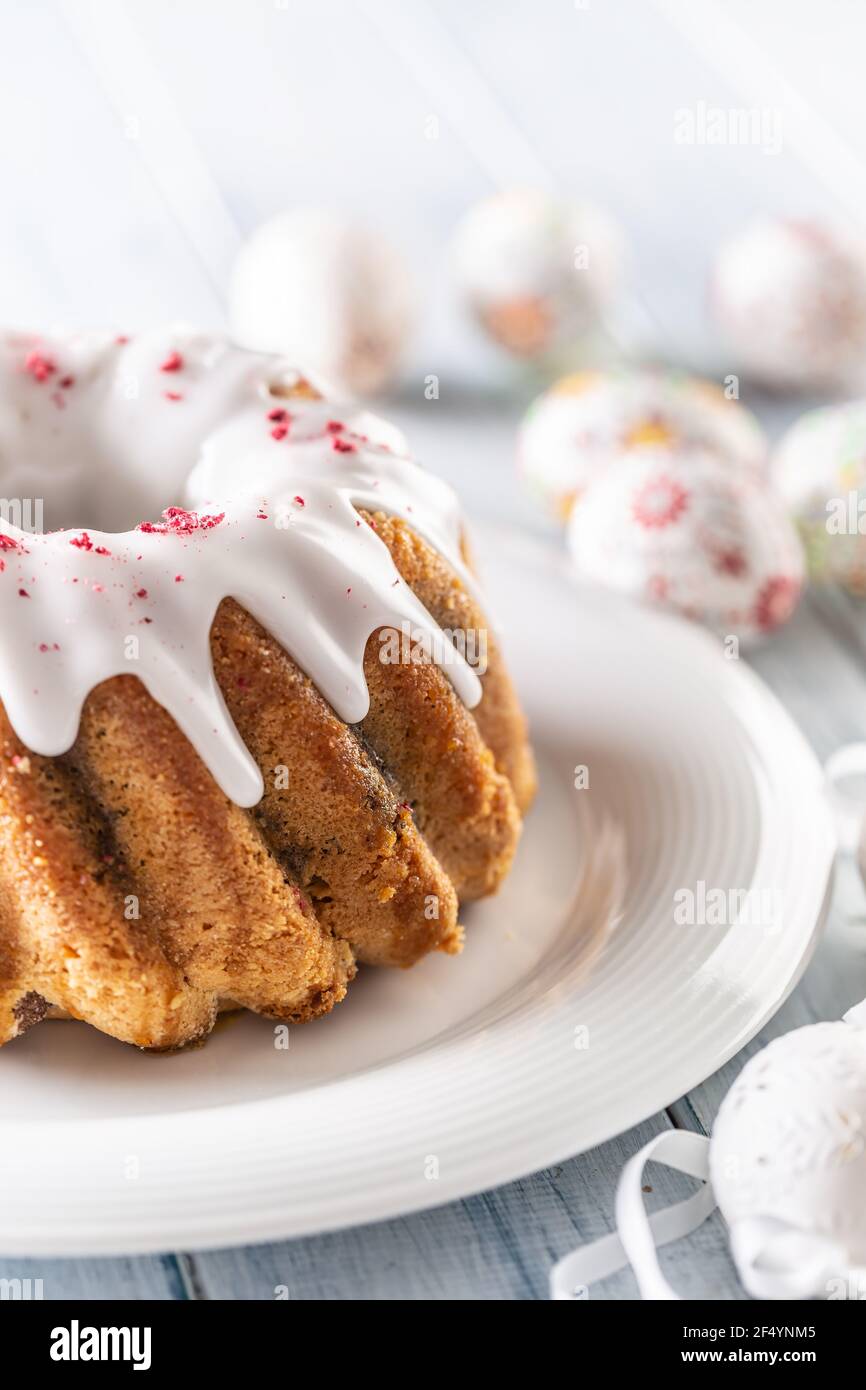 Festive easter marble cake with icing sugar with hand-decorated eggs. Stock Photo