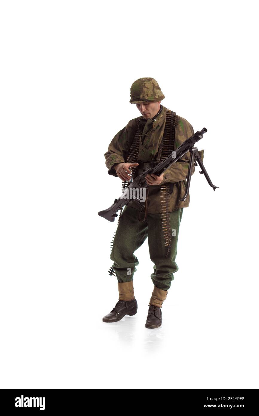 Man actor in the movie role of an military man with a machine gun ...