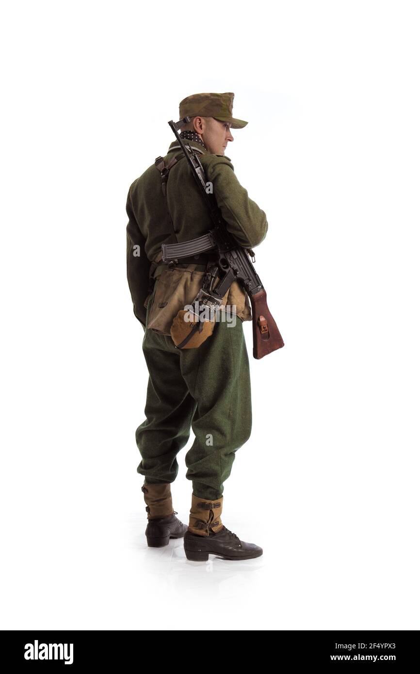 Man actor in the movie role of an military man with a machine gun ...