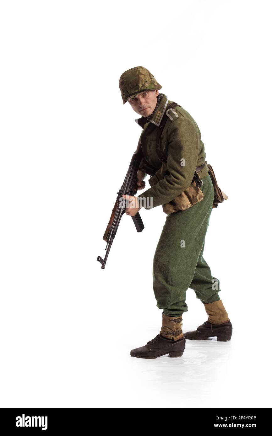 Man actor in the movie role of an military man with a machine gun ...