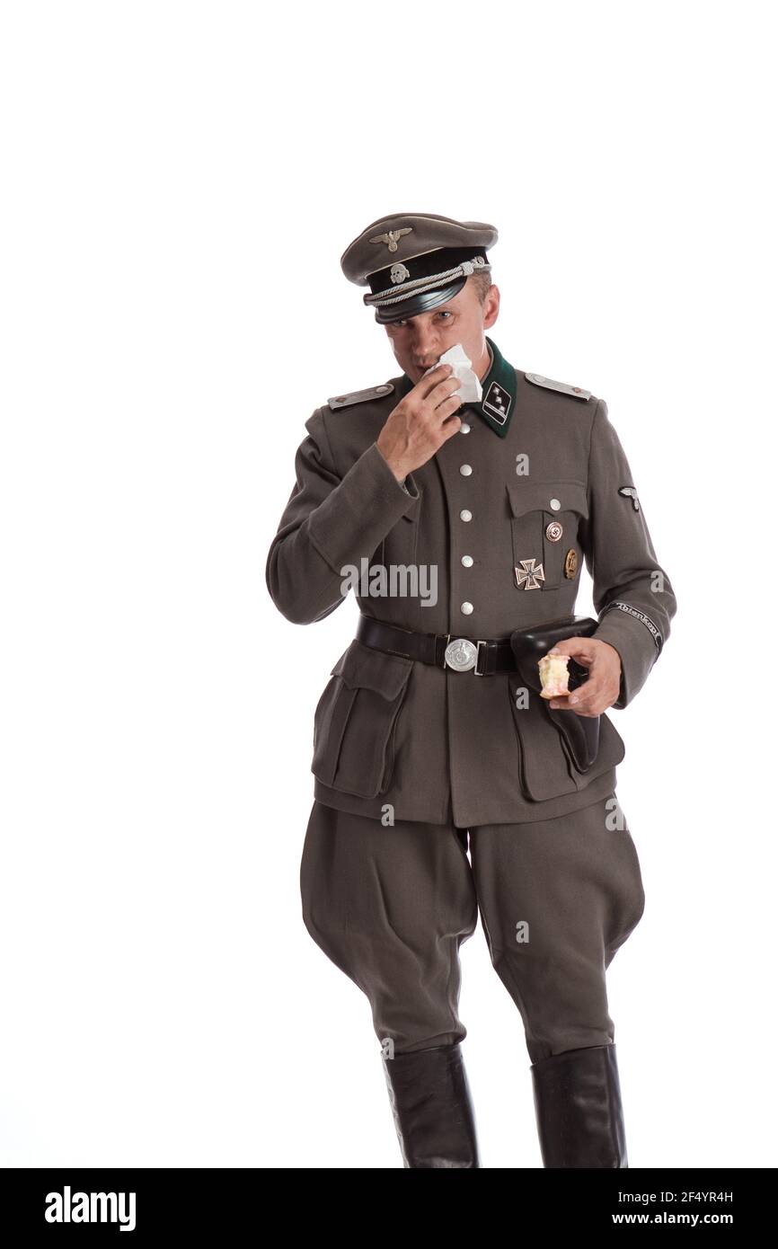 Man actor in historical military uniform as an officer of the German Army  during World War II, posing on a black background in a blue scenic light  Stock Photo - Alamy