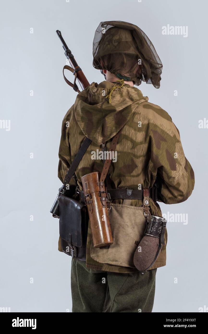 Actor man in an old military uniform and camouflage sniper marksman  clothing of a soldier of the German Army during World War II Stock Photo -  Alamy