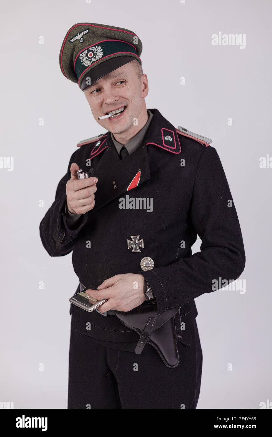 Male actor reenactor in historical military tank uniform as an officer of  the German Army during World War II to smoke a cigarette on a white  backgrou Stock Photo - Alamy