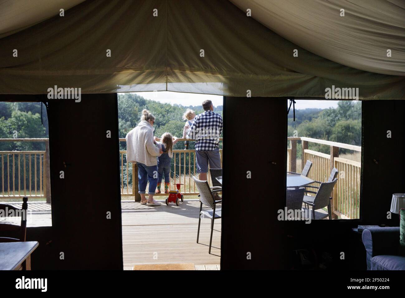 Family on sunny yurt tent balcony Stock Photo Alamy