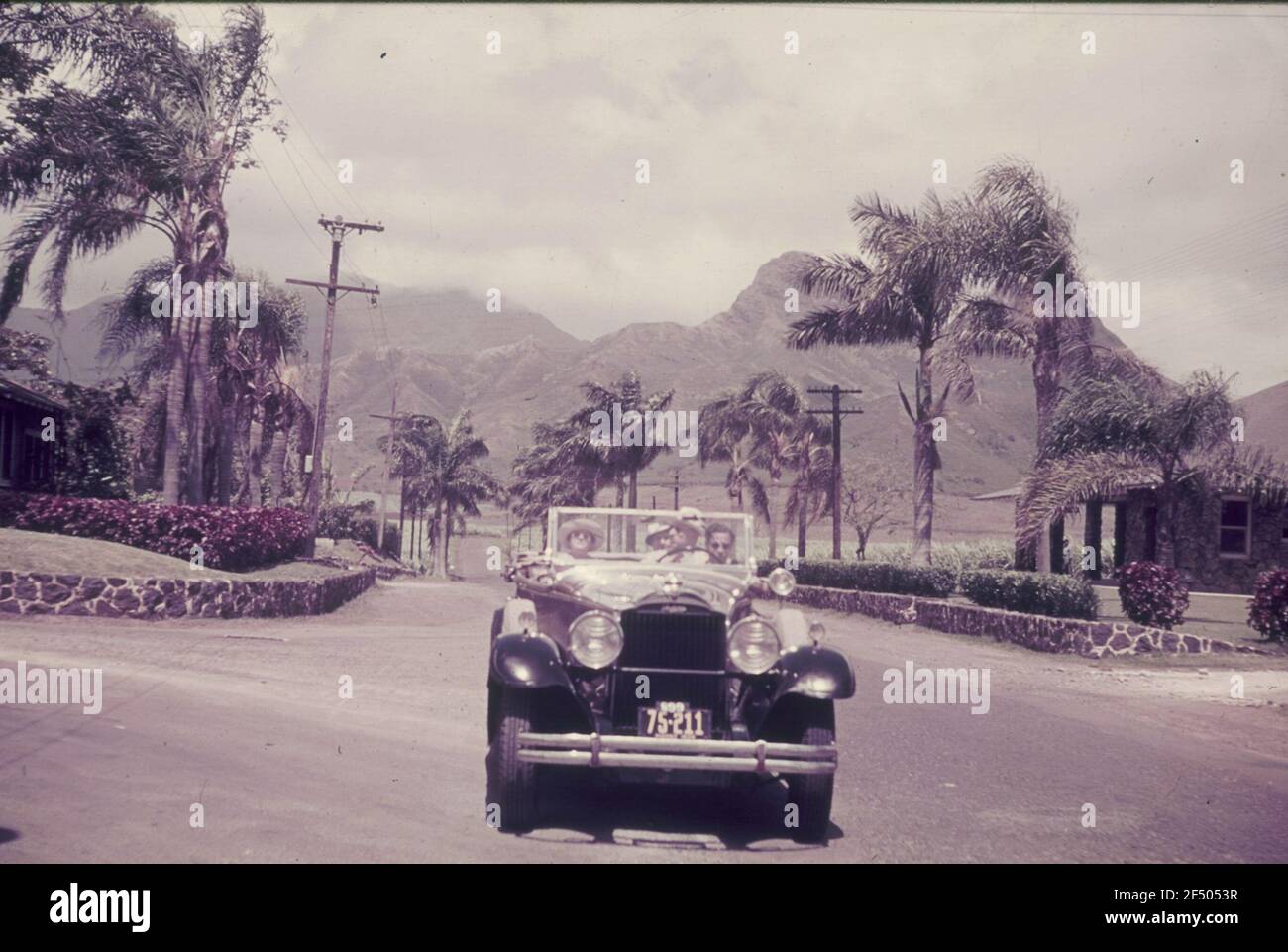 Travel photos. Automotive with left control (car no. S 99 75-211) during a local passage. View to a mountain range (probably in the Spanish or French Caribbean) Stock Photo