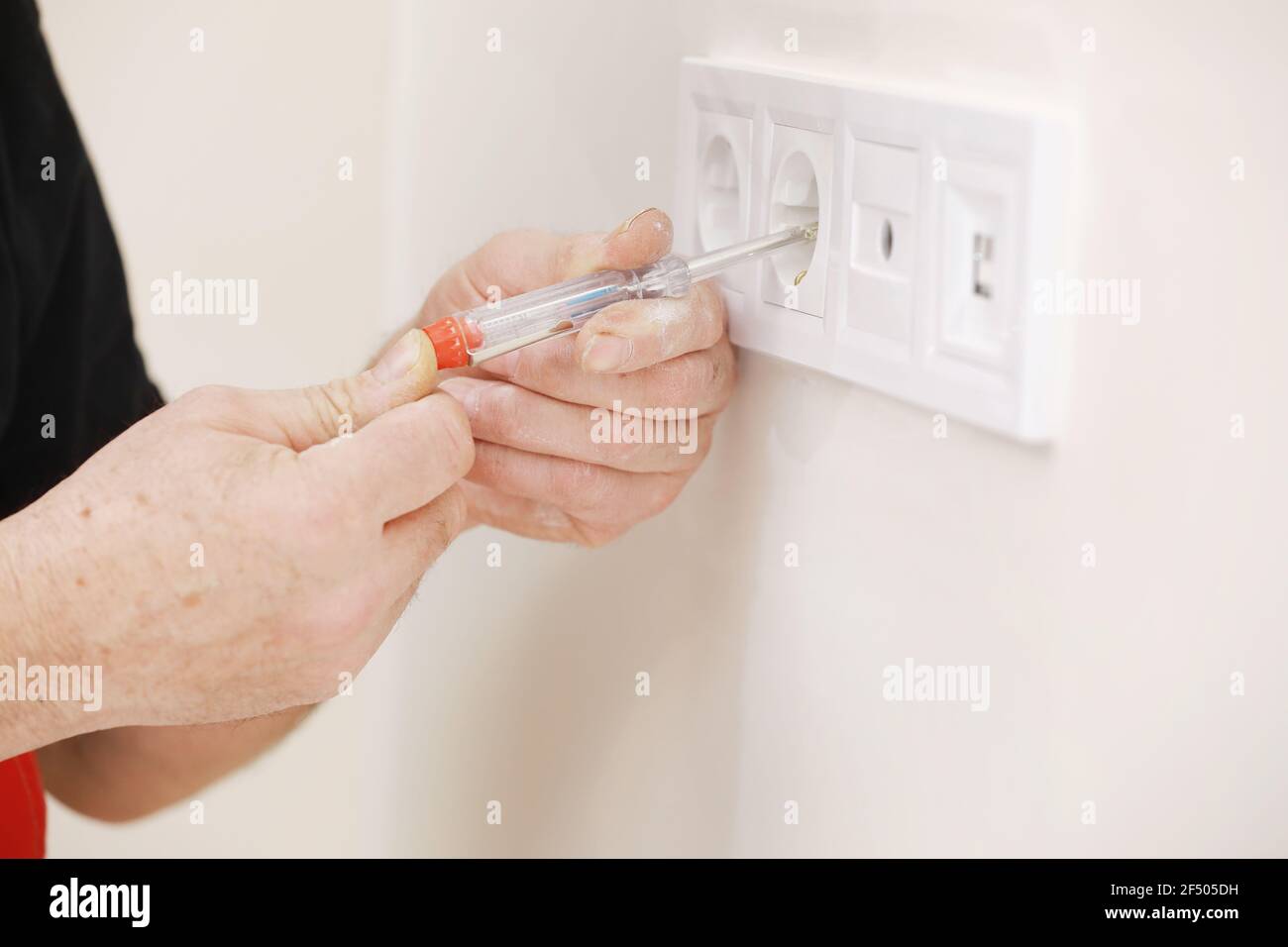 bare wiring on back of light switch in house being redecorated in the uk  Stock Photo - Alamy