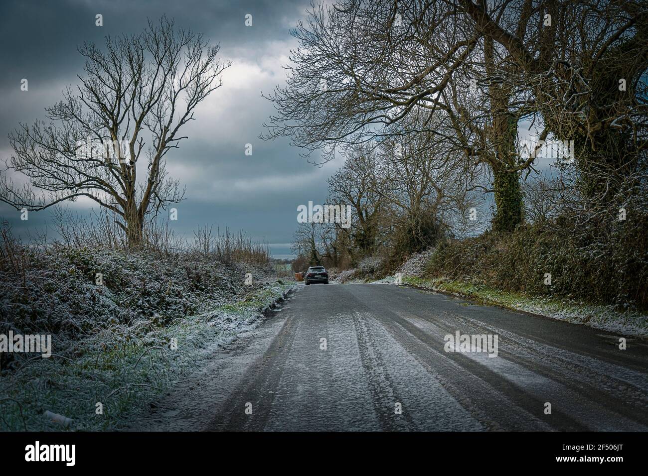 Winter in Ireland. Light snow covering countryside road in co. Wexford