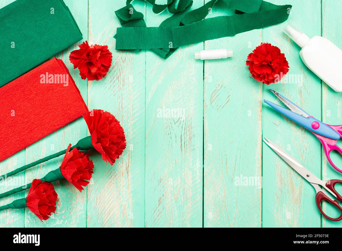 How to make a carnation flower at home. Hands make a red carnation