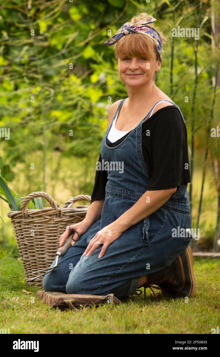 Portrait happy woman gardening in backyard Stock Photo