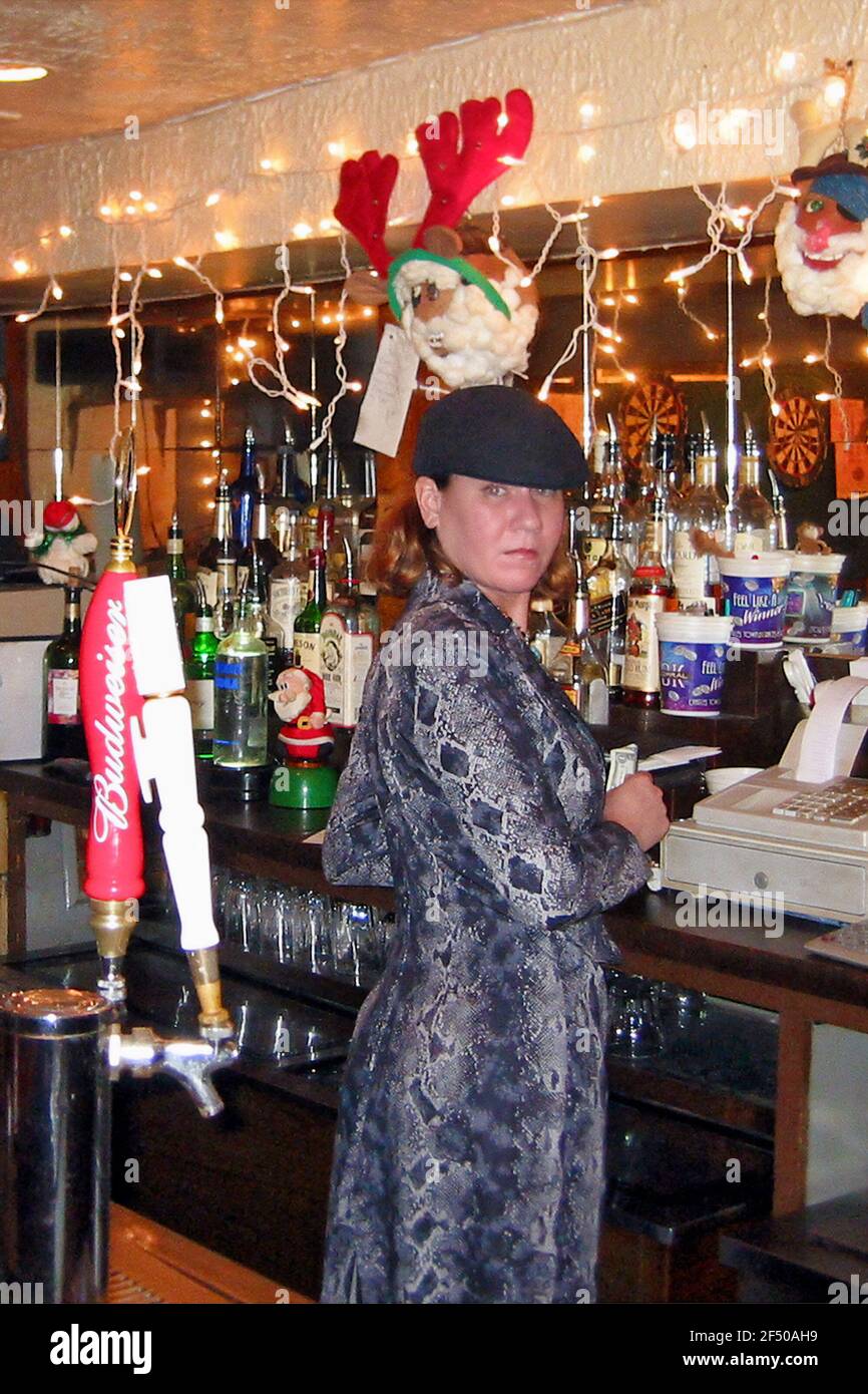 barmaid turns towards the camera in a quiet pub Stock Photo