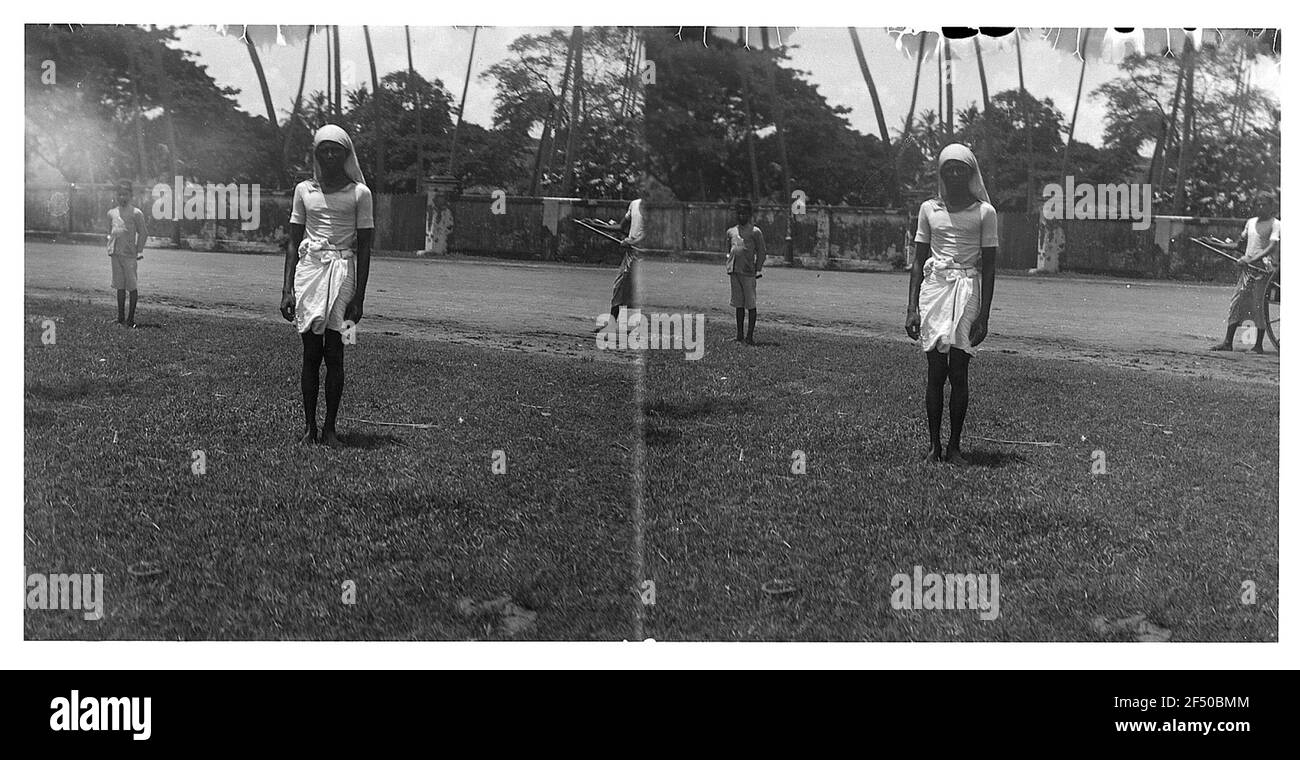 Yangon (?) (Burma). Posing woman with headscarf and towel around the hip on a lawn Stock Photo
