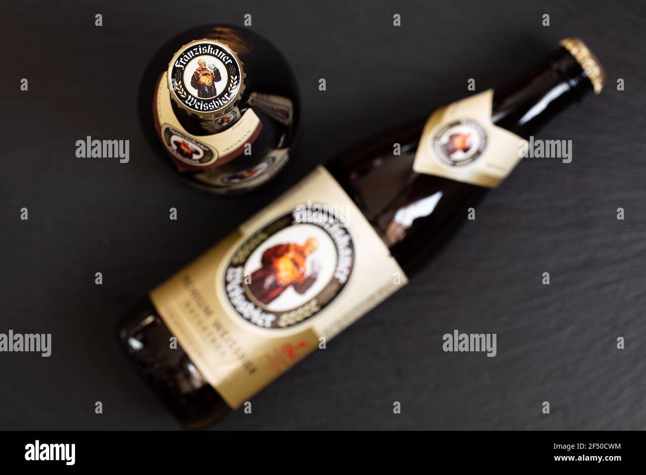 Munich, Germany - March 23, 2021: Bottles of Franziskaner Weissbier, products of Spaten-Franziskaner-Breau GmbH, on black background Stock Photo