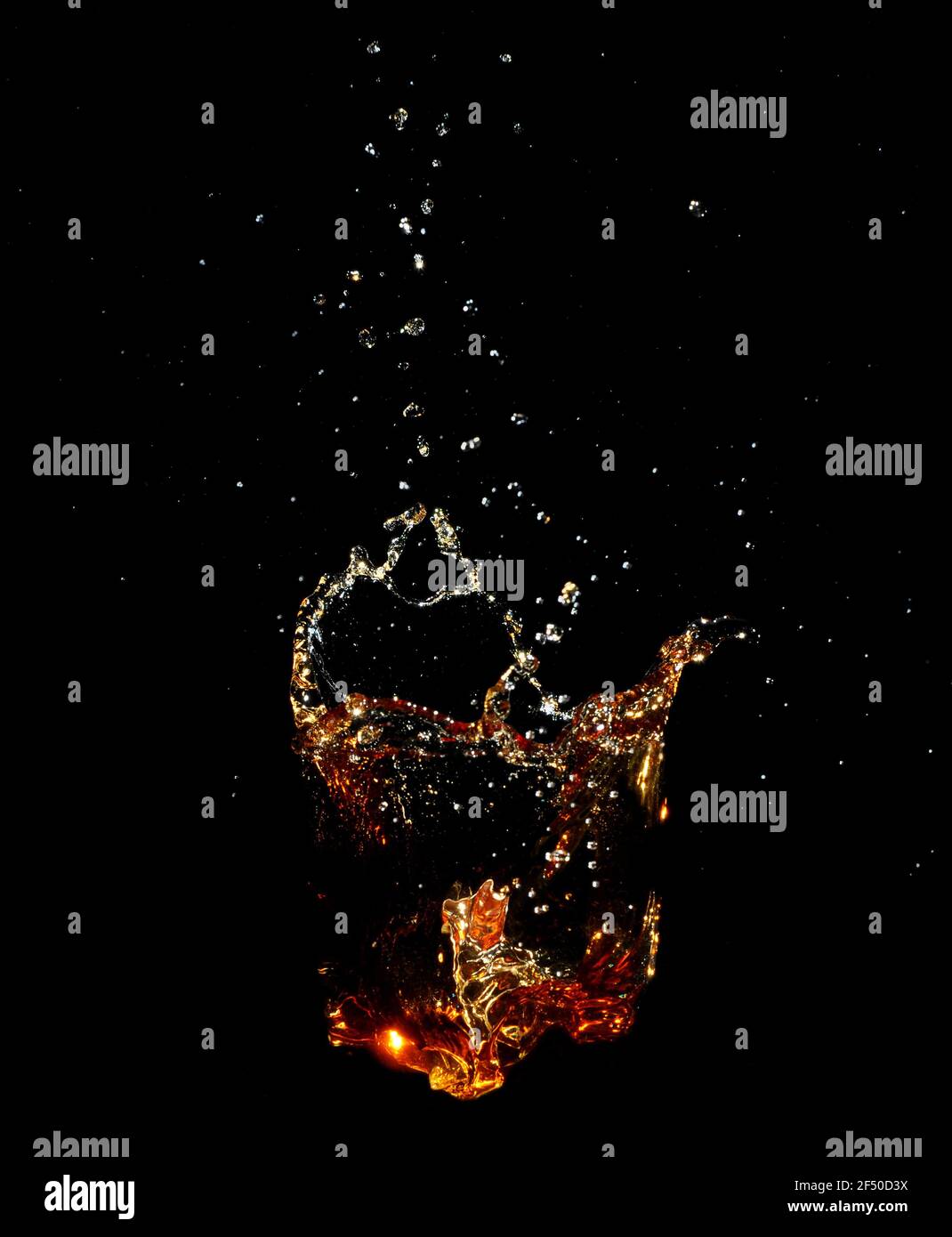 Whiskey splash isolated on black background. Stock Photo