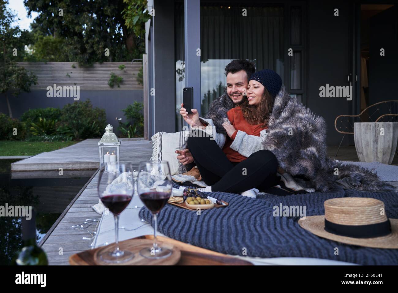 Happy couple taking selfie on luxury. hotel patio Stock Photo