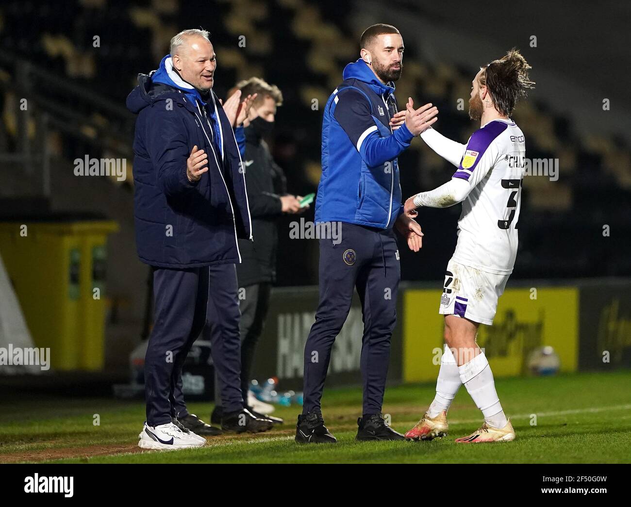 Shrewsbury Town's Harry Chapman (right) celebrates scoring their side's second goal of the game Shrewsbury Town assistant manager Aaron Wilbraham during the Sky Bet League One match at the Pirelli Stadium, Burton upon Trent. Picture date: Tuesday March 23, 2021. Stock Photo