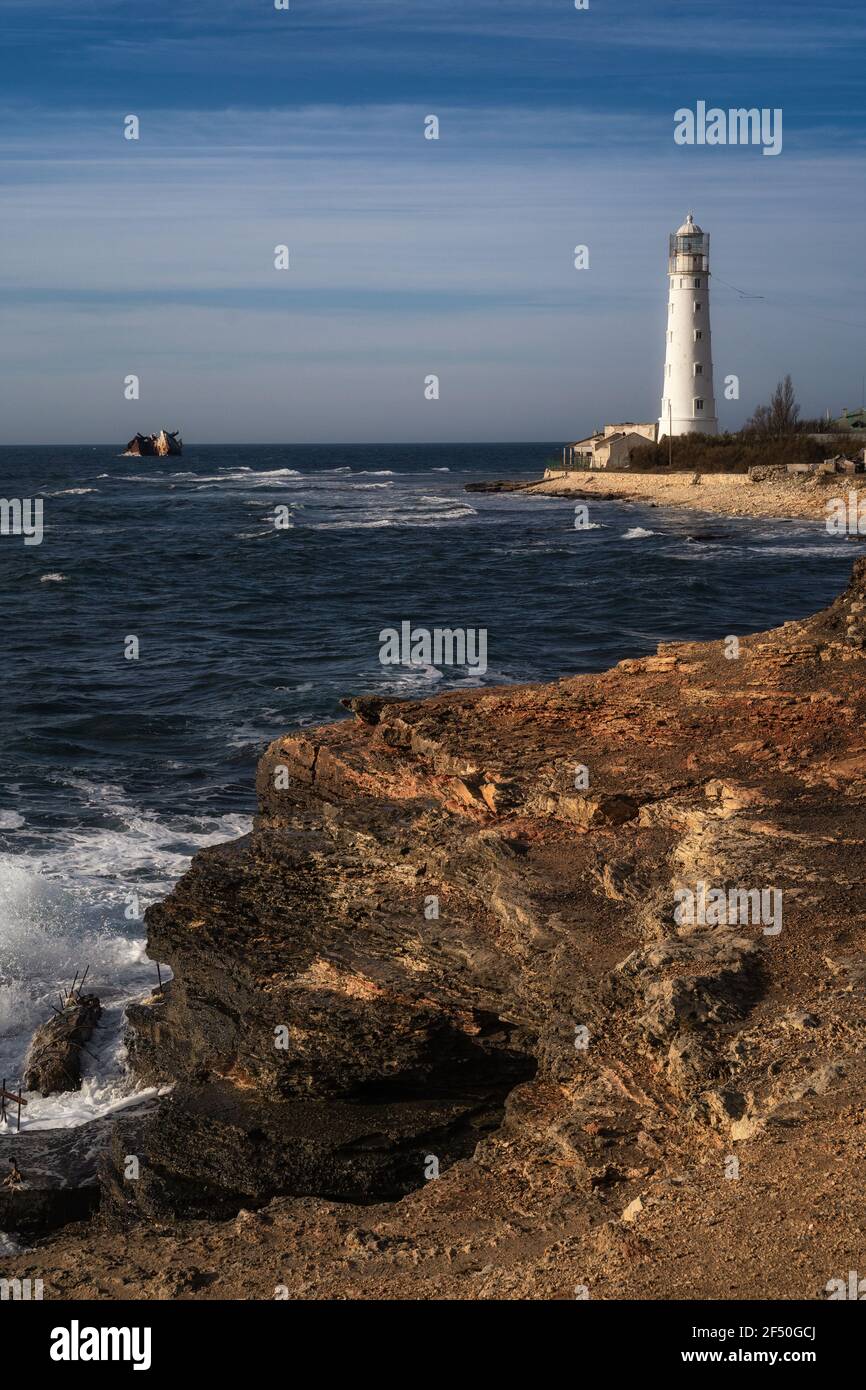 Lone beacon guards the ships. The lighthouse shows the way for boats ...