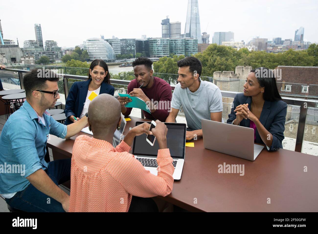 Diverse group of business people meeting on urban balcony, London, UK Stock Photo