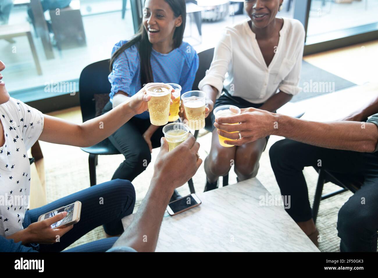 Business people toasting beer glasses in office Stock Photo