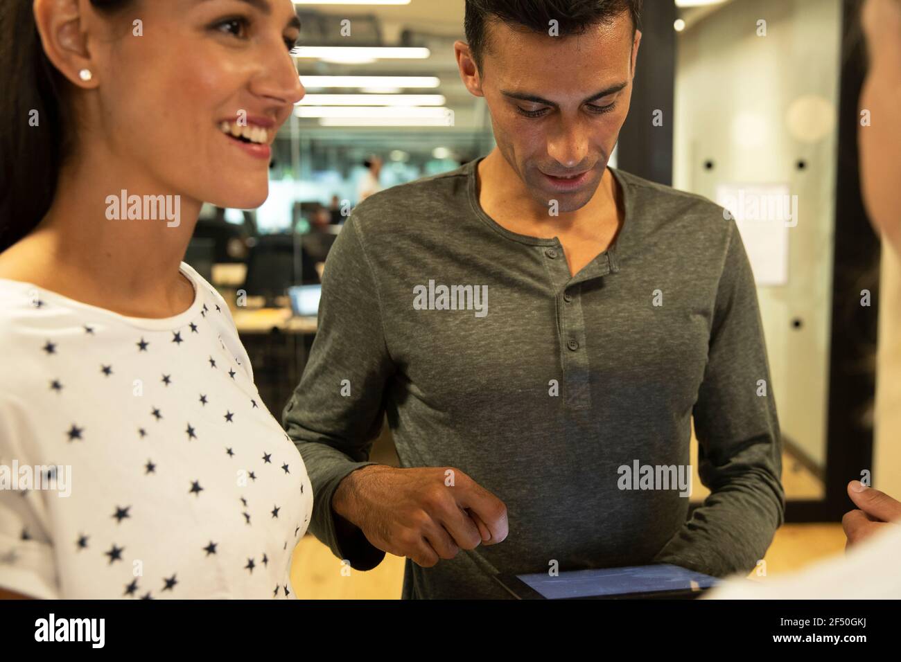 Business people with digital tablet talking in office Stock Photo