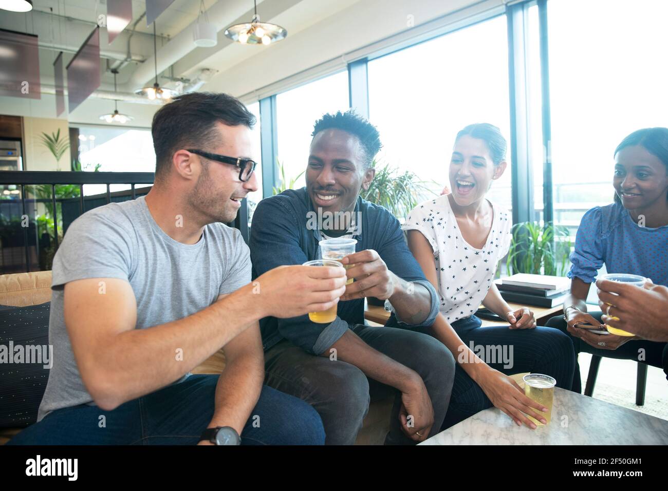 Happy business people celebrating with beers in office Stock Photo