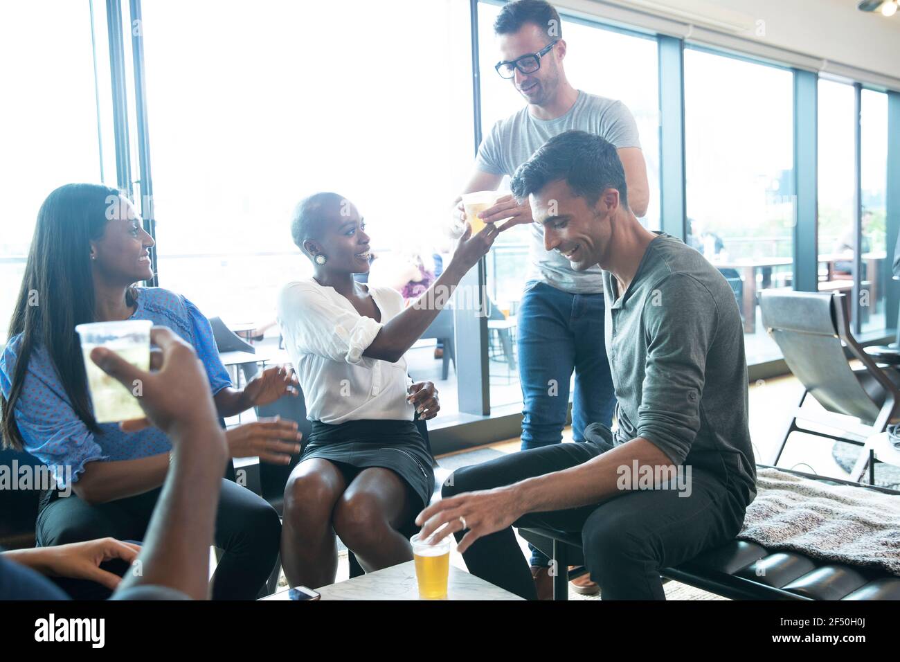 Business people celebrating with beers in office Stock Photo