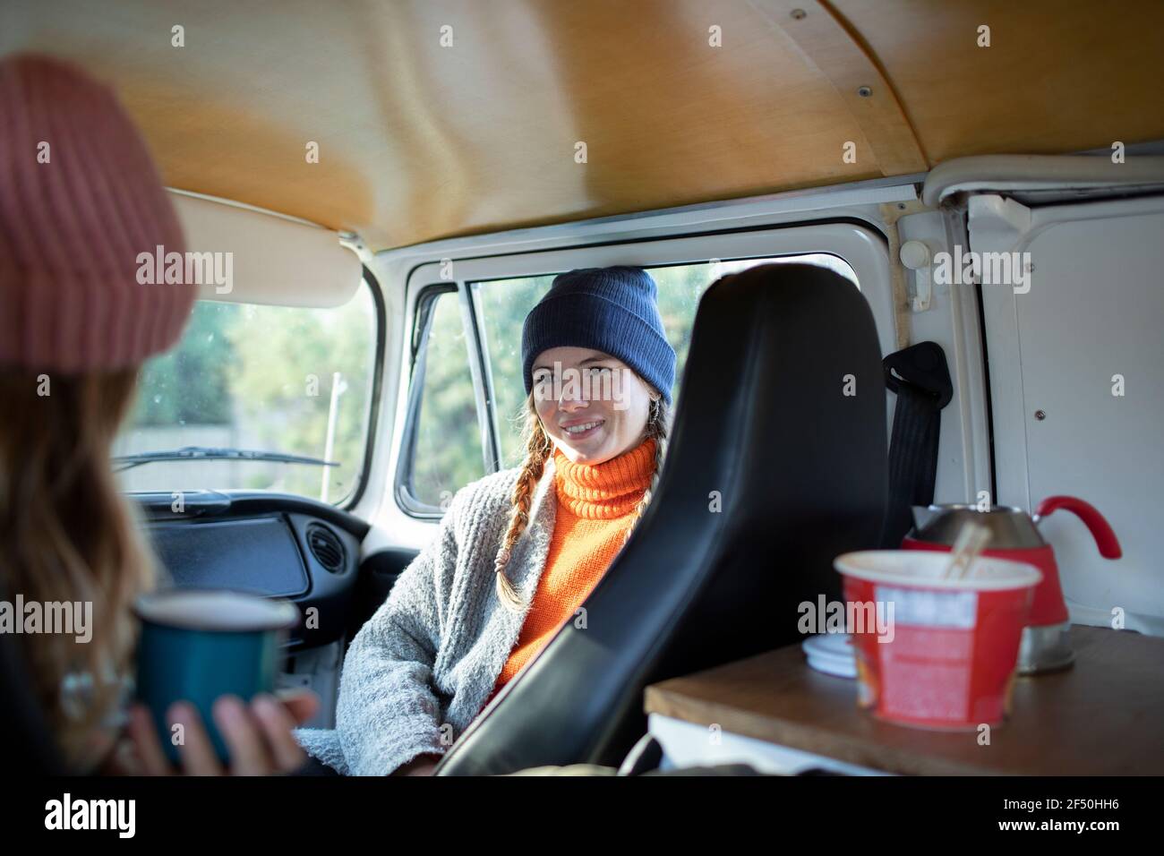 Young women friends relaxing in camper van on road trip Stock Photo