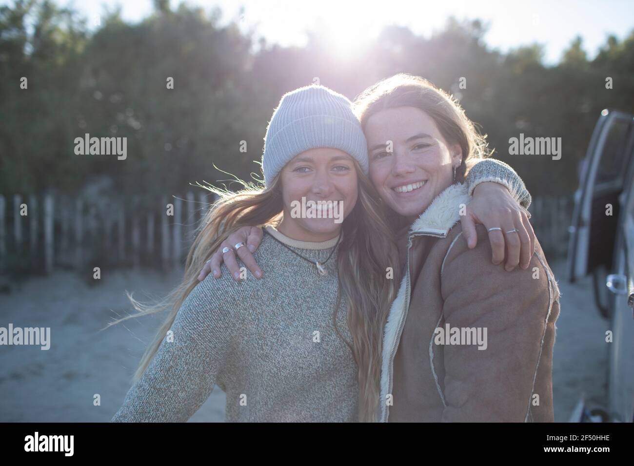 Portrait happy young women friends hugging outdoors Stock Photo