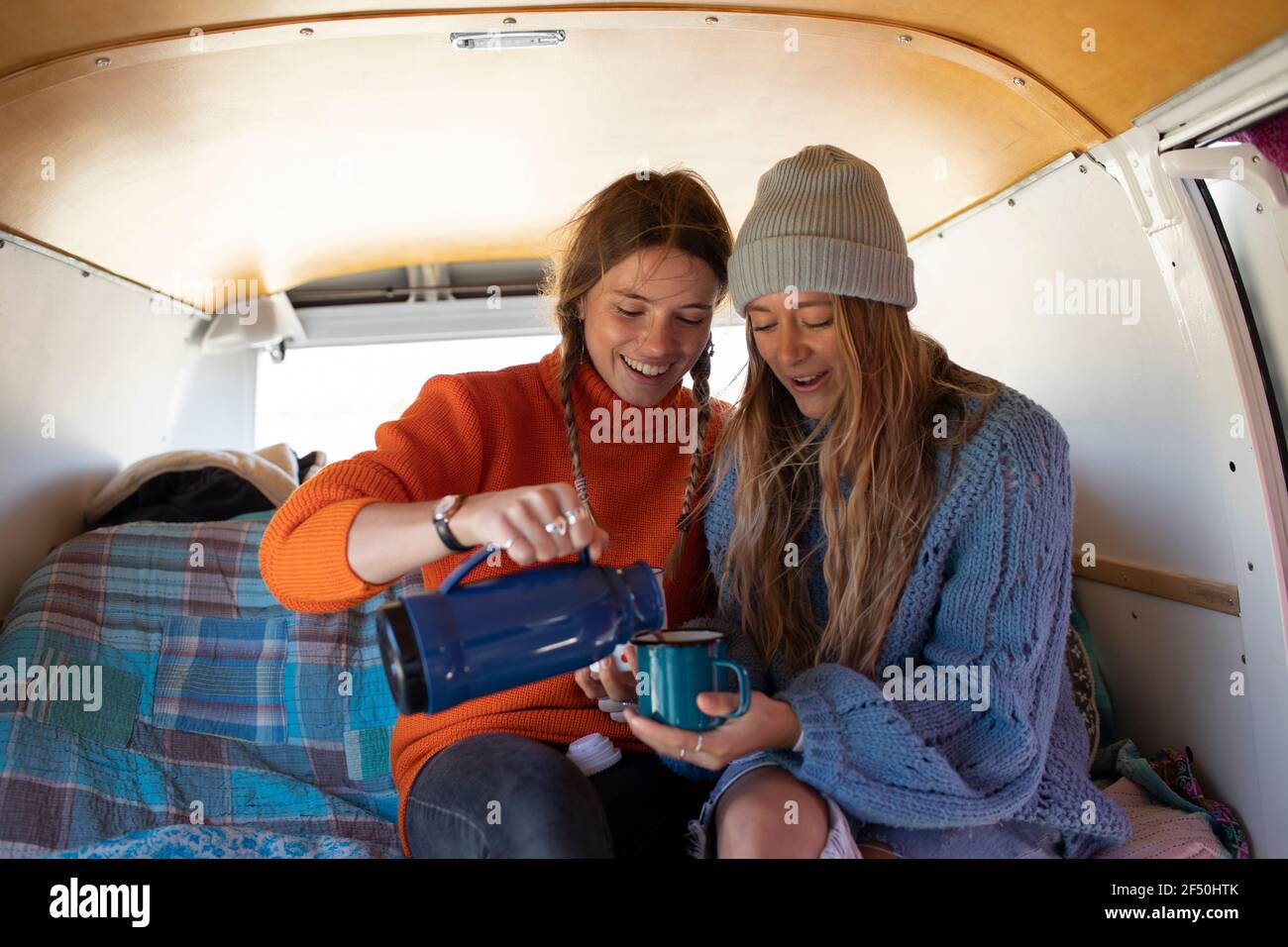 Young women friends enjoying coffee in camper van Stock Photo