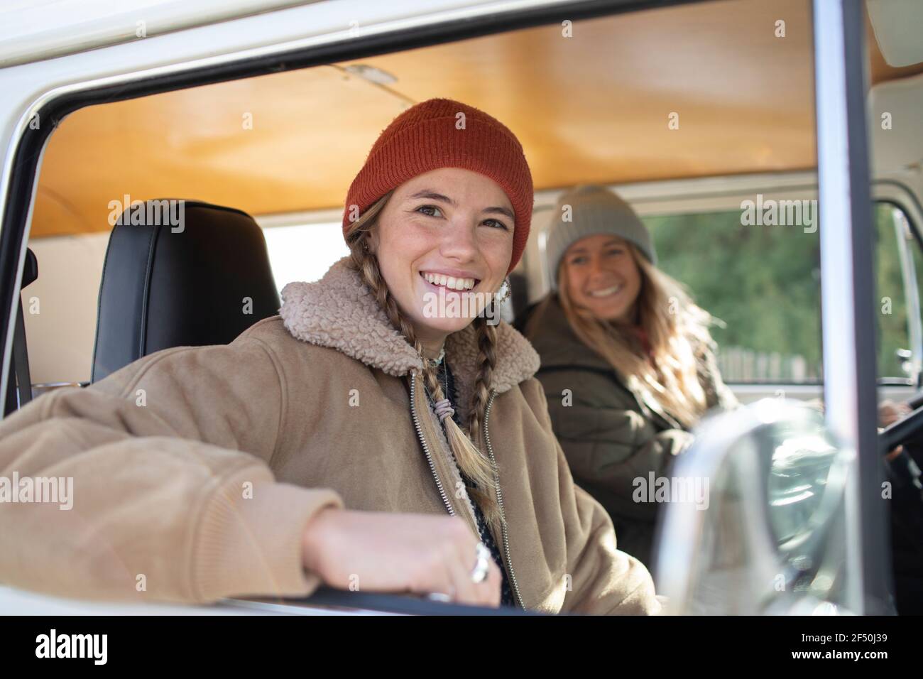 Portrait happy young women friends inside camper van Stock Photo
