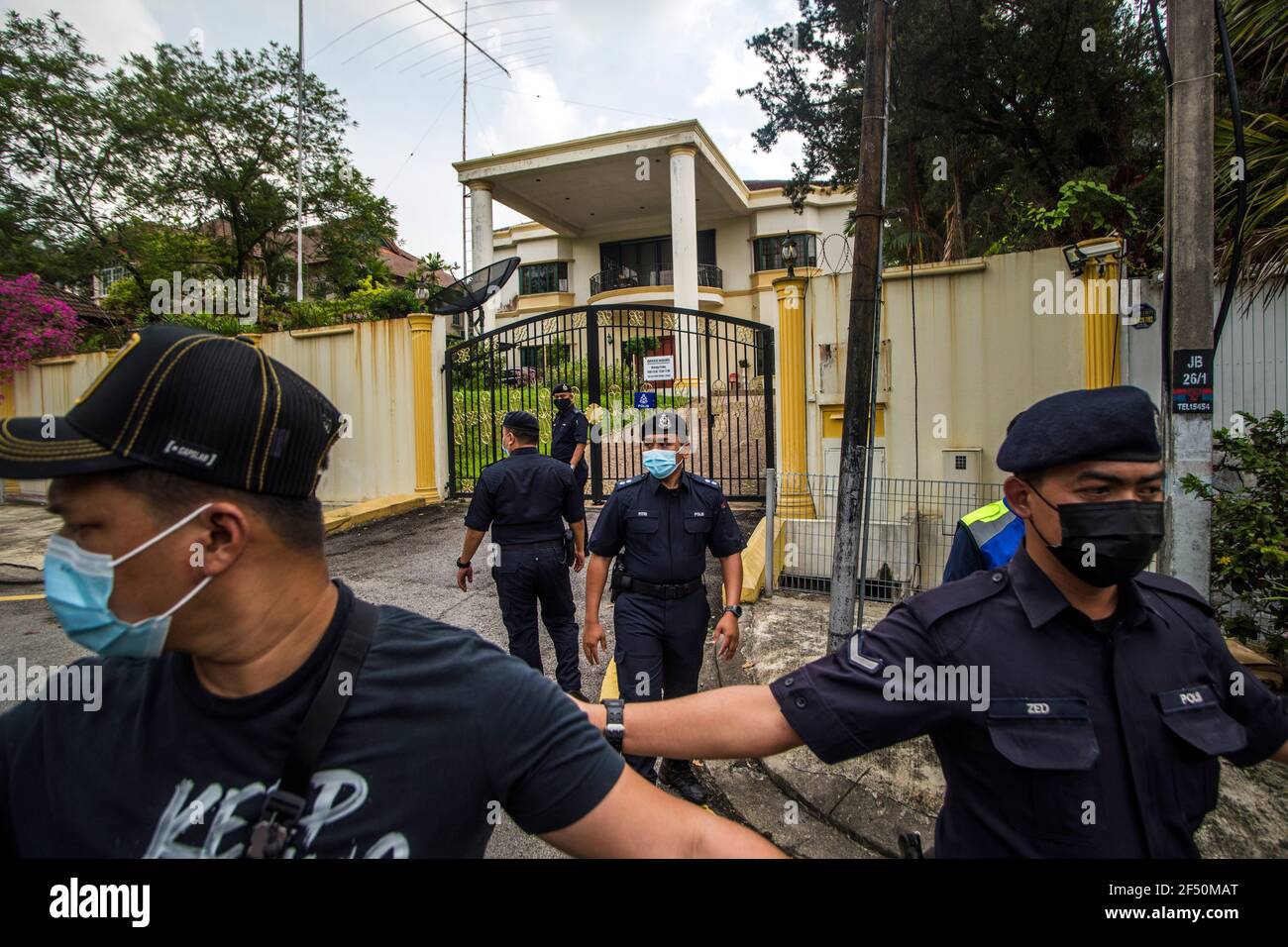Royal Malaysian Police officers stand on guard at the entrance of the North Korea embassy in Kuala Lumpur.North Korean staff left the country's embassy in Bukit Damansara, Malaysia after Pyongyang cut diplomatic ties with Kuala Lumpur for extraditing a DPRK national to the U.S. Stock Photo