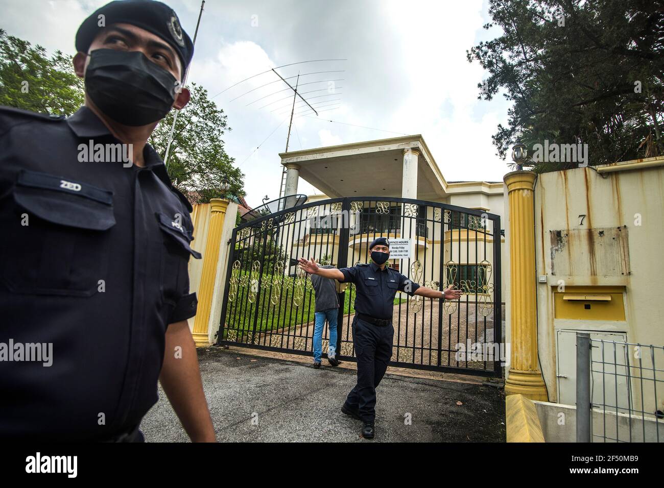 Royal Malaysian Police officers stand on guard at the entrance of the North Korea embassy in Kuala Lumpur.North Korean staff left the country's embassy in Bukit Damansara, Malaysia after Pyongyang cut diplomatic ties with Kuala Lumpur for extraditing a DPRK national to the U.S. Stock Photo