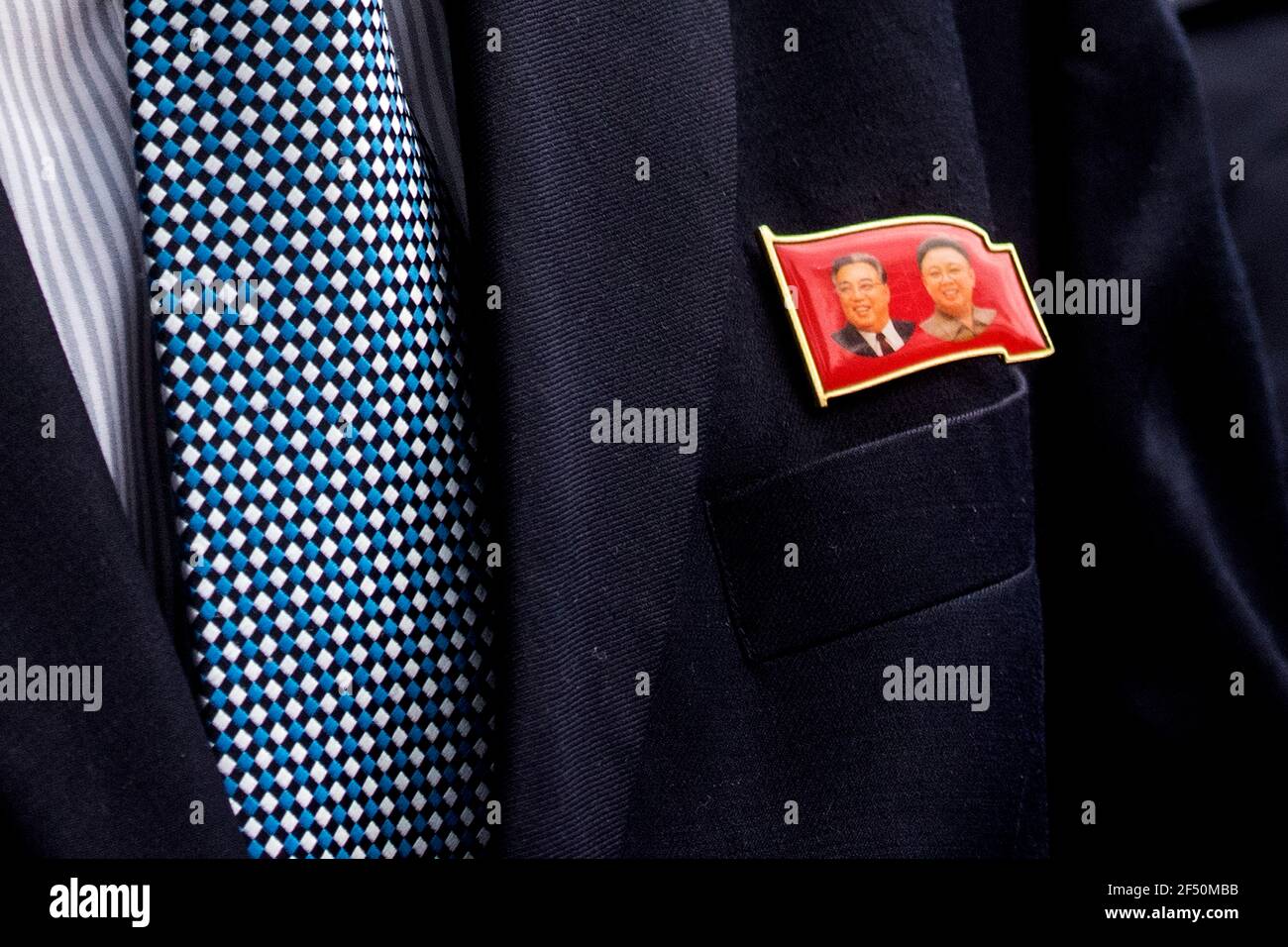 A badge worn by Kim Yu-song, North Korean counsellor depicting former leaders Kim Il Sung and Kim Jong Il seen outside the embassy in Kuala Lumpur.North Korean staff left the country's embassy in Bukit Damansara, Malaysia after Pyongyang cut diplomatic ties with Kuala Lumpur for extraditing a DPRK national to the U.S. Stock Photo