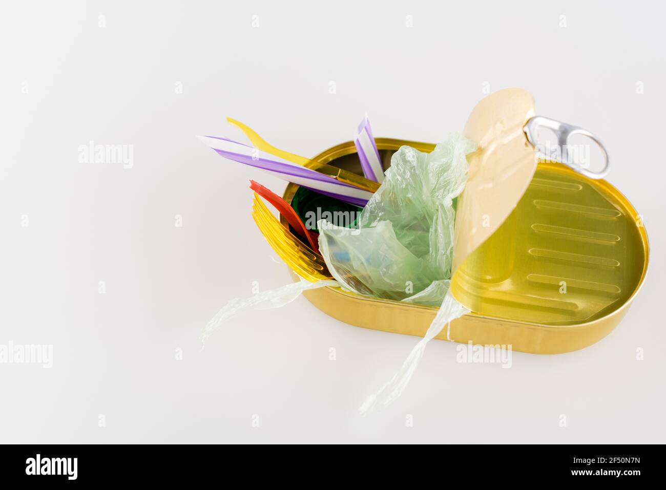 cellophane and plastic garbage in can on white, ecology concept Stock ...