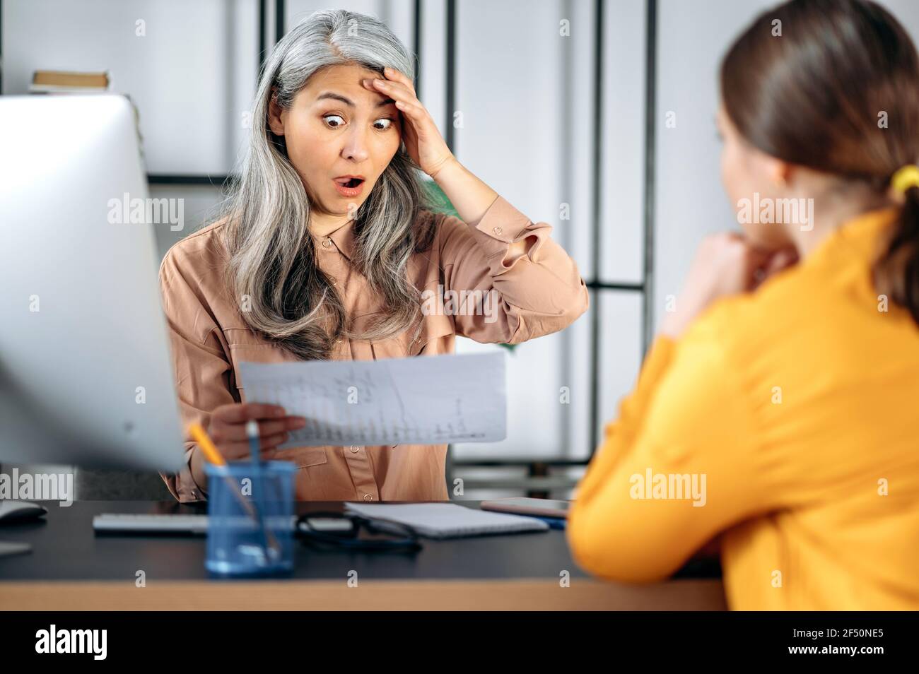 Shocked indignant mature gray-haired Asian woman, business leader, top ...