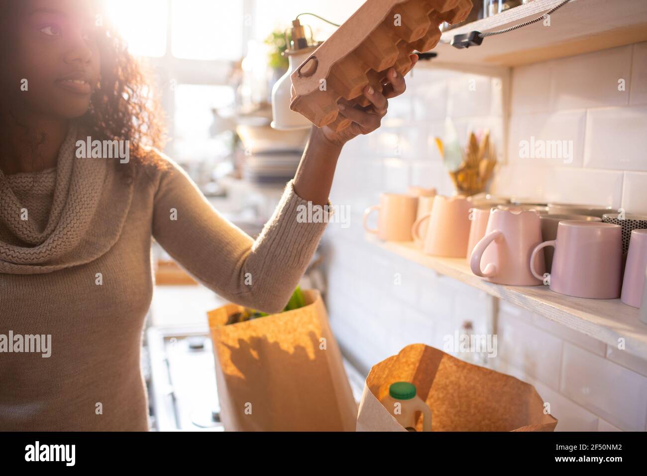 Woman unloading groceries in kitchen Stock Photo Alamy