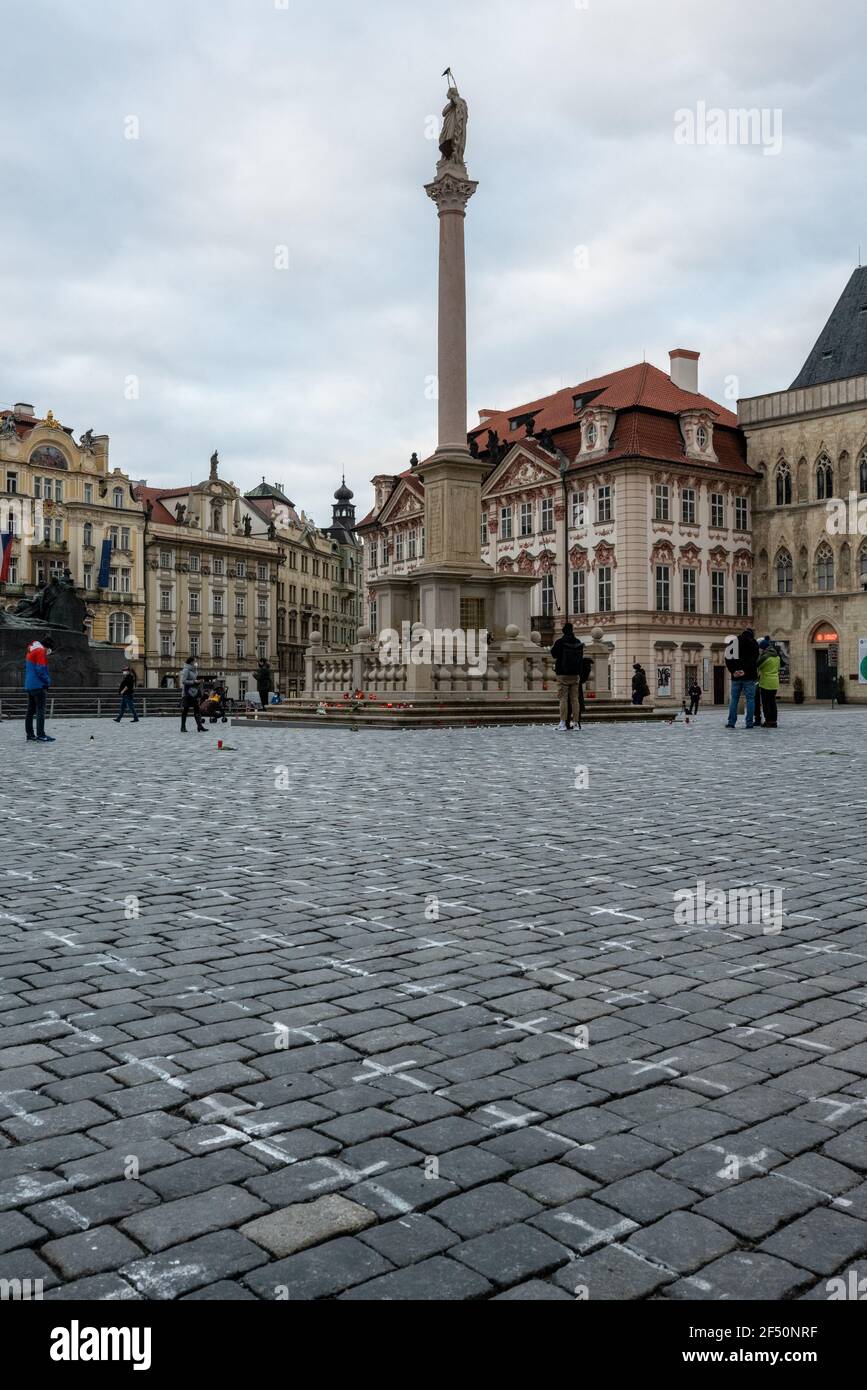Prague Old Town Square with Marian Column and chalk crosses painted in memory of Czech victims of Covid-19 and as a protest against Babiš government. Stock Photo