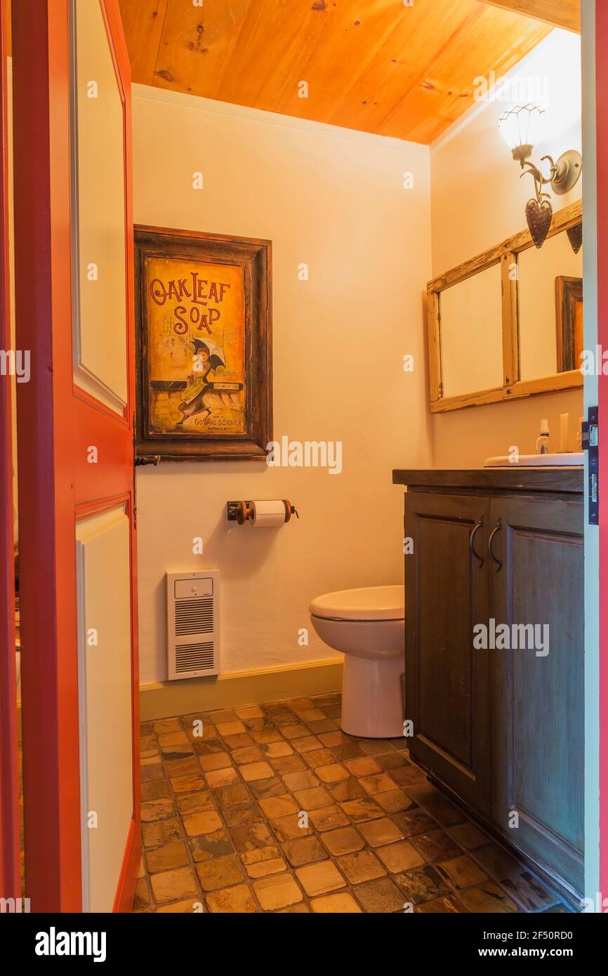 https://c8.alamy.com/comp/2F50RD0/wooden-cabinet-with-top-mounted-sink-standard-toilet-in-water-closet-with-nuanced-earth-toned-ceramic-tile-floor-inside-an-old-circa-1735-house-2F50RD0.jpg