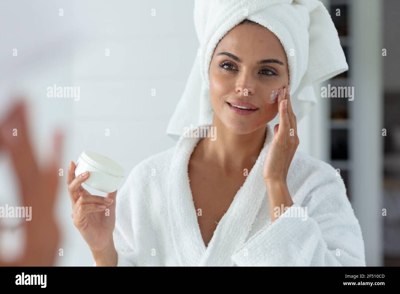 Woman putting cream on her face hi-res stock photography and images - Alamy