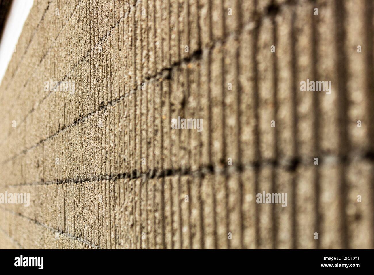 The lines on concrete lead the eye to the end of the wall. Stock Photo