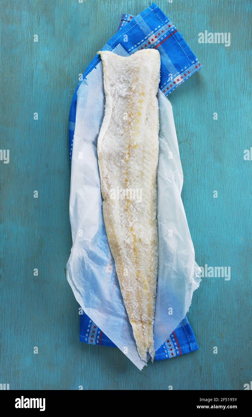 Wet salted cod fillet on turquoise kitchen towel Stock Photo - Alamy